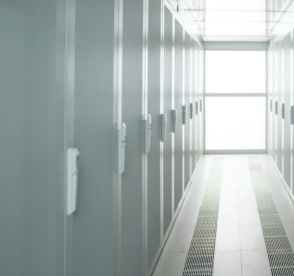 Modern, light server room with rows of server cupboards